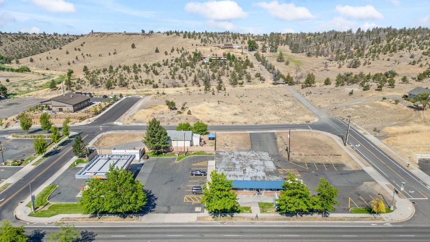 This property is one of the best commercial properties in Central Oregon.  Over 30,000 cars a day pass.  Easy traffic flows.  The fueling station is leased for nine more years and was built in 1999 with 10 fueling stations.  Or you can own the fueling station if desired.   The convenience store is a perfect size with two built-in walk-in coolers and a deli.  There is a busy pub with lottery machines in the back of the store.  The convenience store has been in continuous operation since 1968!  Across the street is one of the busiest McDonald's in all of the Northwest.  The business opportunity and all of the fixtures are included in the sales price.  The inventory is to be purchased outside of closing.  This is a turn-key operation ready for a new owner.  Small rental house is also included.  The lot is three tax lots totaling 53,143 square feet.  There is room for more retail growth.  Seller is owner of the property