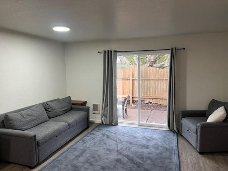 Location, price, and updates - this one has it all! Turnkey townhome with new windows, doors, and lights! Newer flooring and paint throughout home. Light and bright end unit has fully fenced backyard w/ patio and room to garden. Ideally located near all services, schools, parks, shopping, bus lines, freeway access!  Kitchen and half bath updated.  New roof in '25. Newer fridge, range, and W/D included.  Keep your car nice and dry this winter in the attached garage that also provides additional storage.  This address is in the Liberty Elementary zone.