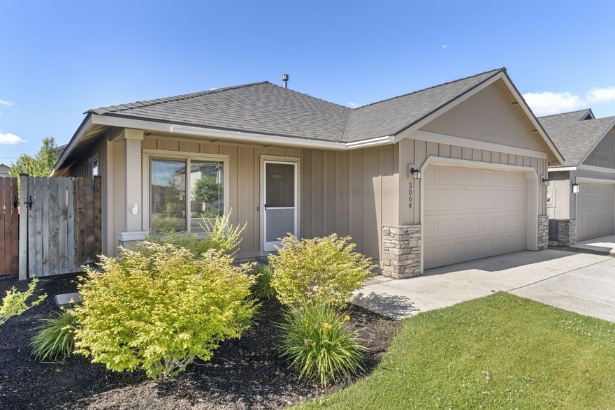 This beautiful Craftsman home welcomes you with a covered patio & rock accents as you enter the home!  Inside, you'll be greeted with an open floor plan, ideal for modern living. Enjoy the warmth & ambiance of the stacked rock fireplace in the winter, & AC in the summer to keep you cool. The kitchen is a delight with its stainless-steel appliances, Hickory cabinets, gas stove, solid surface counters, kitchen island, pantry & an additional eating area off the kitchen. You'll find attractive laminate floors throughout the main living space, which flow into carpeted bedrooms for cozy toes in the mornings. The primary bedroom has a walk-in closet & double vanities in the bathroom. The front yard is nicely landscaped & has sprinklers for easy maintenance. In the back is a covered patio for relaxing & sipping your favorite beverage. The backyard itself is a blank slate offering endless possibilities for your creative design!