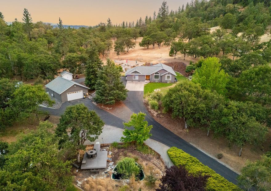 Immaculate home and garage / shop on 9.27 acres, set back off the road down a gated paved driveway.  Home features open floor plan with vaulted knotty pine tongue and groove ceiling with several windows giving an abundance of natural light. Solid surface counters throughout the home with tiled bathrooms, carpeted bedrooms and beautiful hardwood flooring. The kitchen is huge and perfect for entertaining. The primary bedroom includes tray ceiling, walk-in closet, and sliding doors leading you to a gorgeous deck. Primary bath completely updated with double sinks, tiled walk-in shower and soaking tub. Garage / Shop with mini split system, built-in shelving and attic storage! The property includes 3 decks, an ornamental pond, lawn areas including an area for in-ground pool, sprinklers, garden area, garden shed with mini split system, chicken coop, dog run, and RV parking, tons of extra parking for all your toys! A total of 3 mini split systems. Solar was added just for the hot water heater