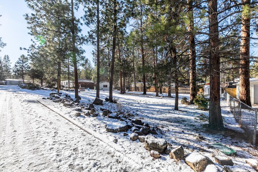 Wonderful nearly third acre lot in Romaine Village close in SW Bend convenient to all the goodies Bend has to offer. Schools, the Old Mill, River Trail and parks very close. Easy access to the Parkway. Mature trees on a ready to go spacious and fenced lot with utilities at street and potential systems development reduction (buyer to do due diligence with the City of Bend).