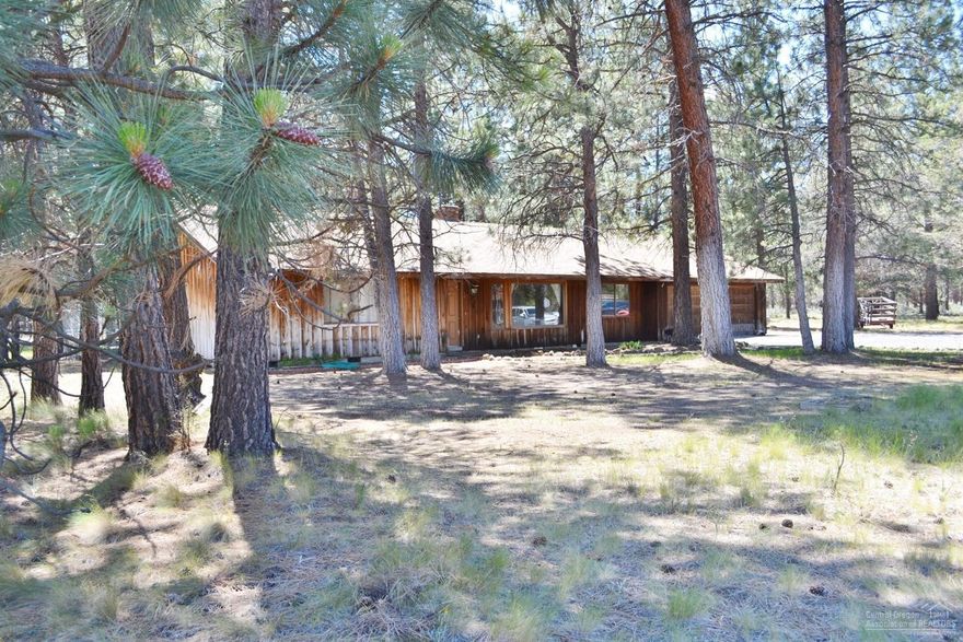 Just over a mile from Sisters, OR, nestled among the Ponderosa Pines and Deschutes National Forest on 5.34 acres sits this 1884 sqft home. Beautiful vaulted tongue and groove ceilings soar above the family, dining, and living room. 3 bed 2 1/2 bath with additional craft room. Large exterior deck peers out to pasture and forest. Multiple outbuildings and room for a garden. This home is waiting for your inspirations and rejuvenation.