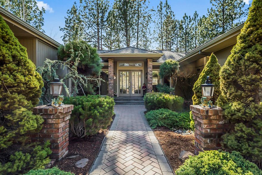 Nestled in Bend's premier golf community of Awbrey Glen, you will find this spectacular single level home that backs to the 8th fairway & views of the pond. As you walk up the paver walkway & enter the home, you will notice the rich built-in cabinetry, gas fireplace & vaulted ceilings with skylights through providing optimal natural light. The chef's kitchen is open to the great room & features granite counters, Jenn Air 6 burner gas cooktop, a large island and beautiful hardwood flooring. In the great room you will enjoy hosting in the wet bar with plenty of seating to watch the big game & includes built-in wine refrigeration. This home also features an office, spacious sunroom & a large laundry/mud room. The primary suite boasts a jetted soaking tub, tile shower double vanity and fireplace. The lush backyard boasts an expansive patio with hot tub, water feature, mature landscaping and a golf cart garage! HOA Amenities include the pool, walking trails, clubhouse, tennis courts & more!