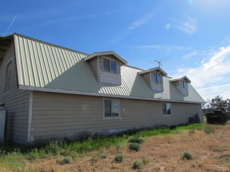 Wonderful opportunity to own some large acreage with beautiful views of the Cascades and other mountains. The current farm building has a 2 bedroom, 2 bath living area with garage on the ground floor & huge attic/loft area on the upper level. The property has a full RV hook up area with water, power and separate septic tank, partial pole barn and some animal pens with gates. Update the current structure or tear down and build your dream home while living in your RV on the property. Loads of potential here!