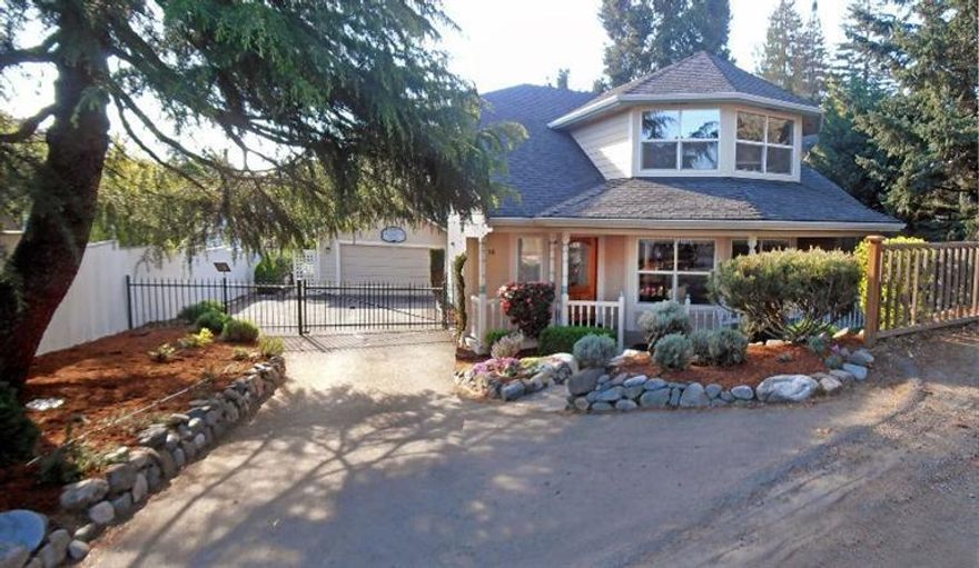 Beautiful home privately tucked away in downtown Ashland just 2 blocks from the Plaza. The nicely landscaped front yard leads you to a covered front porch which invites you into this spacious home. On the main floor you will find a living room with large bay windows, a wood burning stove and wood floors. The bright and open kitchen, dining room and master bedroom suite have views of the backyard and the hills. Upstairs are 2 bedrooms with territorial views, a full bathroom, and a very wonderful family room with bay windows and window seats. A gated driveway takes you to the oversized 2 car garage. You will enjoy the backyard with its large decks, hot tub and garden pond designed for BBQs, gatherings or just lounging. You can walk or bike to anywhere and everywhere - yet you are off the beaten path and all is quiet. Close by is Lithia Park, Ashland Creek, restaurants, the theaters, hiking trails and all that downtown Ashland has to offer. The home is move-in ready.