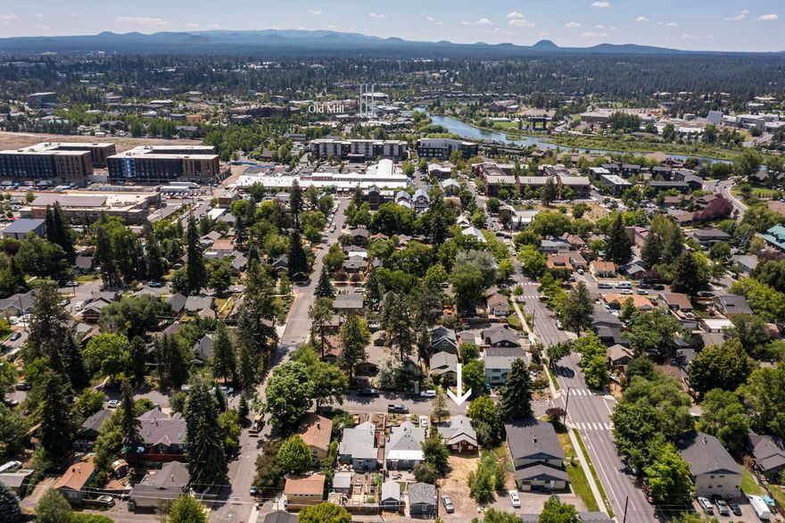 A rare opportunity to own a piece of Bend's founding history in the heart of the Old Town Historic District, the city's first platted neighborhood and birthplace of its mill-town legacy. Situated between NW Bond and NW Staats Streets, just three blocks from the vibrant downtown core and steps from Drake Park. The original 1915 Craftsman bungalow is one of the few surviving residences from the mill boom era, built the same year as the lumber mills that would later form the Old Mill District. While currently uninhabitable, prior renovation plans were approved (an 18+ month process) by Historic Landmarks and City of Bend for three units: a restored 841-sf historic cottage and a new duplex with two 411-sf 1BR/1BA units, plus three off-street parking spaces. Plans have expired and will need updated approval. Once restored, live in the cottage and rent the duplex (buyer to verify regulations), or restore and resell in a peaceful, high-demand neighborhood with an 89 Walk Score.