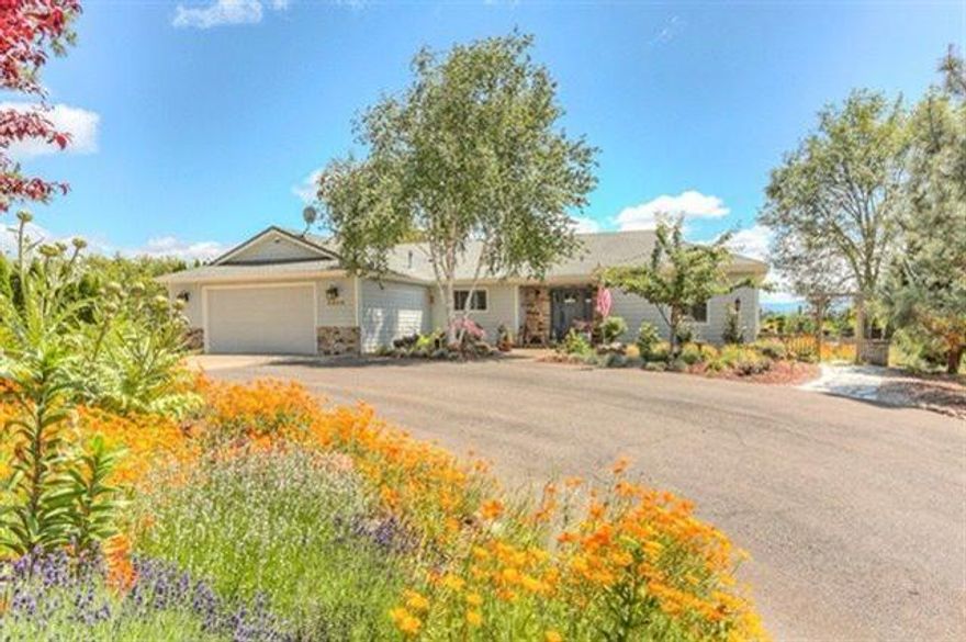 You'll feel at home when you see this well cared for, bright spacious 3 bedroom, 3 bath, 2005 sq. ft. home .89 acres with views of the mountains. Open floor plan, bamboo flooring, gas fireplace, wall of windows to enjoy the views & French doors to the patio. Large kitchen with farmhouse sink, granite counters & eating bar, stainless appliances, tile backsplash, gas oven/range & stainless hood. Split floor plan has two bedrooms & bath, marble counters, low efficiency toilets, privacy door & storage. The master suite has coffered ceilings, glass door, claw foot tub, tiled shower, dual vanities, plus dbl walk in closets. Laundry has sink, storage & large pantry with swing-out doors. Additional features are central vac, shuttered windows, ceiling fans, gas heat & hot water. Beautifully landscaped stone pathways, deck, hot tub, covered patio with fan & 2 water features. This property also has TID irrigation. 2 car garage + a separate 30 RV garage plus full hookup.