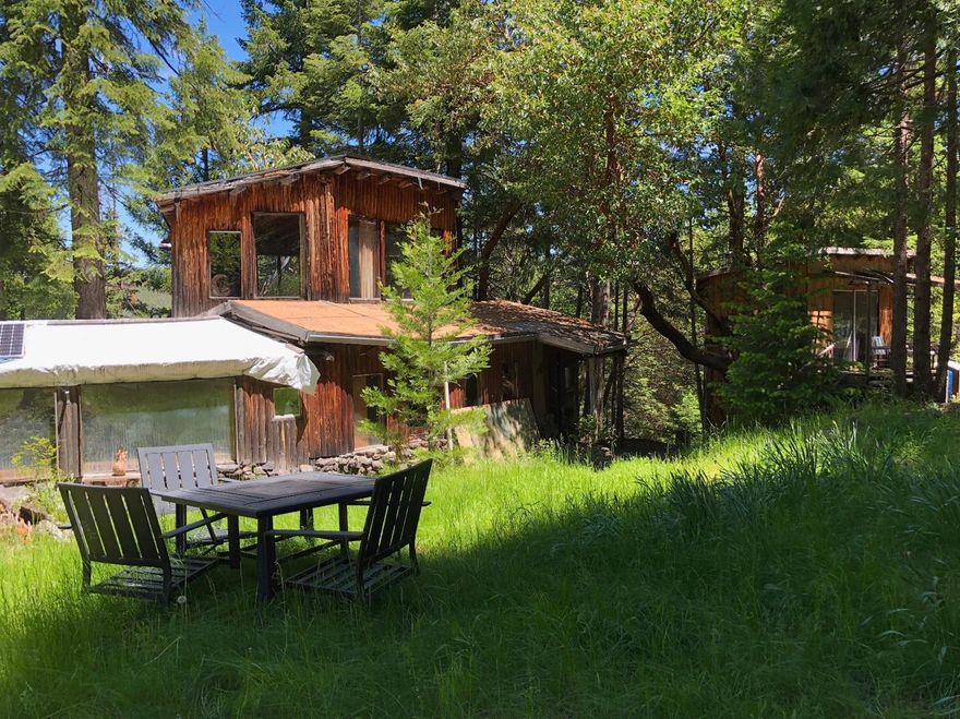 Private Mountain setting in the Applegate Valley with incredible views of the Siskiyou mountains. 20 acres with year round dog fork creek running through the property. This property has a lot to offer: Cabin, Studio, Sauna, Views & Water Rights. Lots of potential for development. Off-Grid; non-expiring homesite, buyer to due their own due diligence. Established garden beds ready for planting. Livable cabin a perfect retreat or live in while you build. Borders BLM on 2 sides. Close to trails for hiking, horseback riding and mountain biking. Located close to local farms. Great secluded location for the outdoor enthusiast.