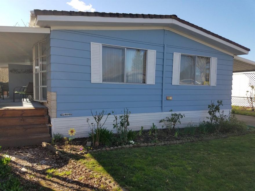 Well maintained 1973 mobile home sits in a very quiet 55+ Senior park a block away from the Mighty Rogue River. In addition to the 3BR/2BA, there is also a possible open family room off the kitchen. Home is heated & air conditioned by a heat pump. Want additional heat? There's a remote controlled propane stove in the living room for radiant heat. In order to use, it will need to be connected to a propane tank. Lots of light in living room provided by large bay windows and good sized windows throughout the home. Storm windows available for winter time. The back yard is fenced and has flowering trees and plants. Along the side and in the front you'll find mint, strawberry and more flowering plants. A covered deck provides a place to enjoy the evenings. The covered carport accommodates two vehicles. An 8'x12' shed provides additional storage. Park manager can explain the pet limitations. A full price offer can include all appliances including the front load matching washer and dryer