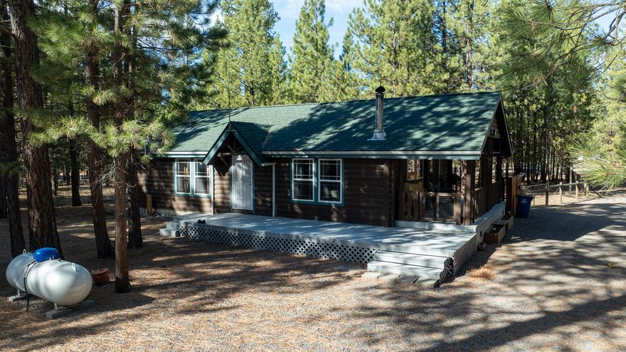 Settle into this well-maintained log-style manufactured home, where you can unwind by the cozy wood stove or take in peaceful forest views from the covered front porch. With over 10 private acres and direct access to public lands and trails, this property offers the perfect blend of adventure and serenity.
Recent upgrades include a new roof and all-new plumbing, giving you peace of mind and added value. Storage and workspace with a 960 sq ft detached garage that includes a third full bathroom, laundry hookups, and electric heat. You'll also find a 1,080 sq ft shop with a separate storage room, loft, and two 360 sq ft lean-tos, plus a 640 sq ft RV shop. Whether you're hosting summer nights around the firepit or heading out for a trail ride, this home is your launchpad for outdoor living.