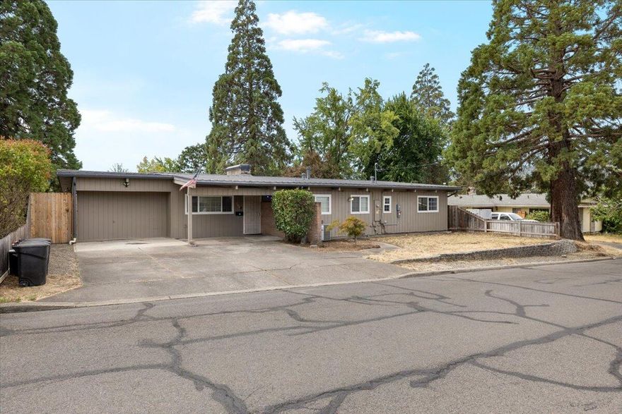 Mid-Century Modern Charmer with stunning tongue-and-groove pine vaulted ceilings and exposed beams throughout! This 4-bedroom home features a spacious living room with picture window, a double-sided fireplace shared with the dining room, and original hardwood floors throughout. Enjoy a brand new kitchen, fully remodeled main bathroom, and updated master bath. The entry has new tile, and LVP flooring is installed in the kitchen, bathrooms, and sunroom. A large laundry room includes extra storage and office space. Outside, enjoy a huge backyard with patio, heated jet pool/spa (handicap accessible), dog run/garden, and detached shop. Bonus features: full solar system, RV parking, and a great location in a desirable neighborhood. This unique and move-in-ready home blends vintage charm with modern upgrades—come make it yours!