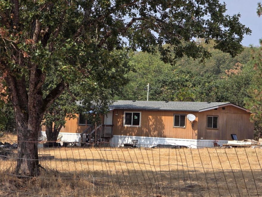 For the price of $ 260,000 for these 4.60 level acres, you can either replace the 1984 manufactured home or repair the double-wide that is on the property—room to plant a garden and room for animals. Call us to schedule an appointment for a must-see property. Holding tanks have been removed.
All information is deemed accurate but not guaranteed and subject to change at any time without notice.