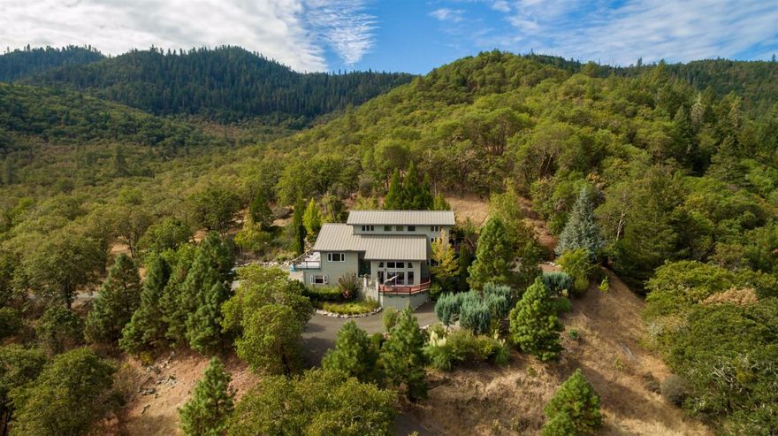 Attention to design and details in this one owner home. Priced to sell $51,000 under recent appraisal! Lg vaulted ceilings with floor to ceiling windows to enjoy your private gated estate on 40 acres with beautiful landscaping and mountains and valley views. Beautiful kitchen with granite counters, lg island, dbl convection ovens, 6 burner gas cook top plus warming drawer 7 walk in pantry. Sunny breakfast room and den off kitchen with lg covered deck and 2nd patio. Amazing formal dining room with another area to enjoy the outdoor decks. Cozy family room with stone wall and efficient pellet fireplace. Living room with huge vaulted ceilings and lg windows. 2 guest rooms approx 15X15 with doors to balconies off each bedroom with lg bathroom between guest rooms. Lg master suite with amazing views! 2 walk in closets with dbl separate bathrooms off suite plus retreat room or great office or library to read your favorite book. 3 Car heated finished garage with work shop area. Lg laundry room