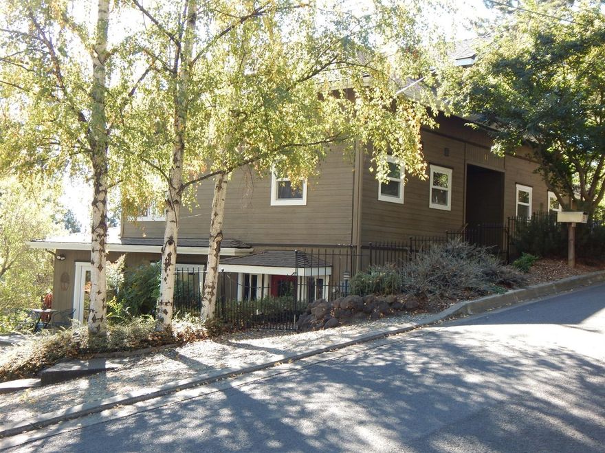 A true Ashland gem... This newly renovated home is set apart by its high walking score and beautiful views! Only two blocks from the world renowned Shakespeare Festival theaters, Lithia Park, restaurants and shops. Enjoy cooking in the gourmet kitchen, and dine off the deck overlooking the valley and the east hills, including a great view of Grizzly Peak. On a larger lot for the area, the expansive, half-circle driveway is an envy of the neighborhood. The home was remodeled in 2015 using a blend of modern and craftsman architecture with attention to detail throughout. The large master suite, living room, dining room, half bath and kitchen are on the main level using only the finest of materials, including hardwood floors, granite counters, travertine tile, & Thermador stainless appliances. The upstairs level includes 2 spacious bedrooms and a bathroom. The lower level includes a yoga/fitness studio with a bathroom, also a family room with an extra guest bedroom and bathroom.
