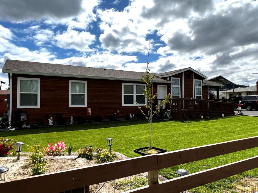 NEW PRICE! Meticulously maintained newer manufactured home on block foundation. Gated/paved drive w/loads of parking/ storage buildings. Large great room w/gas fireplace insert, vaulted ceilings, coffered ceilings, ceiling fans, recessed lights, large windows, large kitchen w/breakfast bar, hard surface counters, pantry, farm style sink/commercial style custom faucet, glass top range/oven, microwave space saver/hood/fan, double door refrigerator, plant shelves, open dining area w/access to large covered patio, impressive master bedroom w/dual walk in closets, upgraded mater bathroom w/double sinks, custom ledgestone style shower surround, Office/den has plenty of room for media and may be considered a 3rd bedroom as it has ingress/egress and a portable closet. Large mud room to the rear of the home w/access to the back yard w/another covered patio, Tuff Shed outbuildings/additional storage sheds. Steel carport/covered RV pkg. w/30amp service/full hook ups. Near Asante,/schools/parks.
