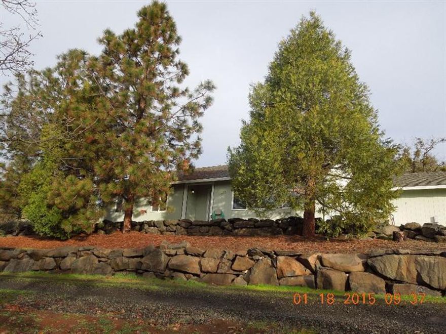 Ranch style home with view of the city night lights and panoramic mountain and valley views. Private but not isolated. Fenced pasture area with barn. Separate shop, 2 car attached garage, nice patio out back, concrete apron and walkways. Beautiful rock walls surround the home. Very well maintained 3 bdrm 2 bath home. High producing well, in-ground sprinklers and hot tub. Inside, vaulted ceilings, zonal heat and heat pump for year 'round comfort.