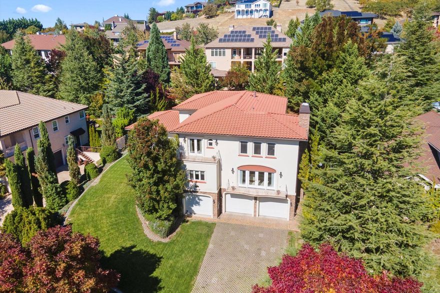 Enjoy sweeping valley views from this South View Terrace one owner custom built home. Stunning sunsets and twinkling lights at dusk in this peaceful sought after location. Near the country club, shopping, vineyards & top medical! Elevator access on all three levels. Main level features kitchen/dining/ living room w/amazing views!  Office w views, plus 2 ensuites each w/ tranquil patio seating areas! Upper level offers large primary ensuite w cozy gas fireplace, incredible views off of the verandas. 2 additional ensuite's each feature a splendid outdoor balcony overlooking the waterfall & manicured private grounds!  Bonus room also w/views! Home easily accommodates multi generational living~it is so spacious & luxurious! Very efficiently built using ICF construction & radiant heated floors!  Notice Mediterranean and Old World architectural flair! Gorgeous mature lush grounds are a peaceful sanctuary w koi pond and waterfall! Finished garages offer plenty of room for the car collection!