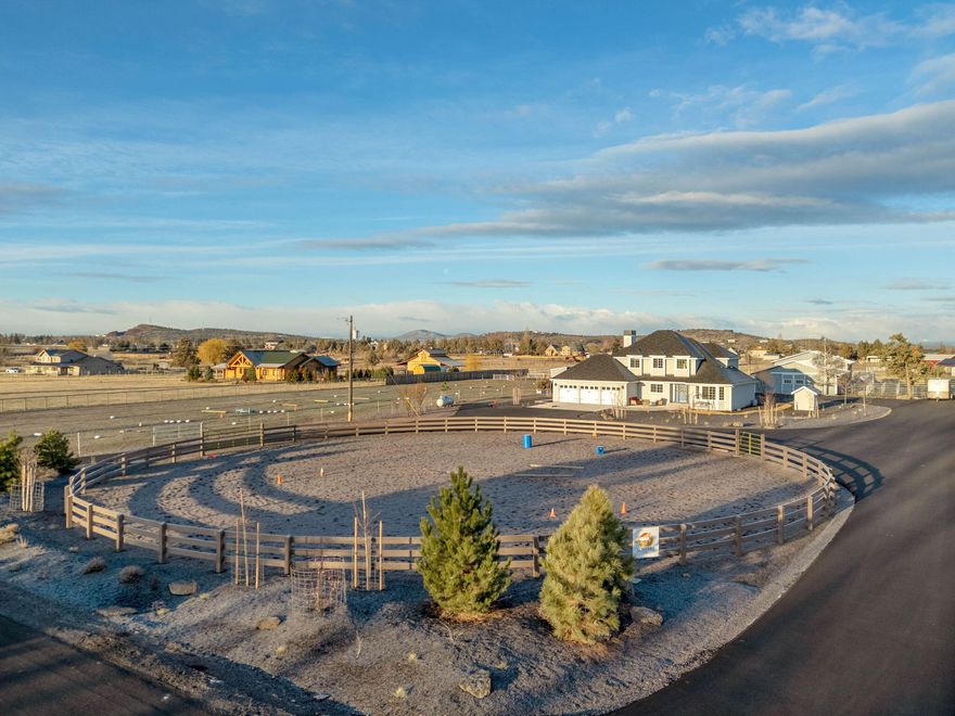 Idyllic horse acreage with custom home, booming mountain views, water rights (4.55 acres), farm deferral and extremely low maintenance. Turn-key horse set-up: 5 stall barn; 3 run-ins; irrigated arena; cross fenced pasture; heated tack room; cement aisle; covered hay storage; concrete manure box; automated pasture irrigation; frost free hydrants; pea gravel paddocks; french drains. Interior features: hardwood flooring throughout; posts and beams; kitchen with granite counters, pantry, stainless appliances, farm sink, floating shelves; large mudroom; large and updated primary bedroom and bathroom with walk-in tile shower, walk-in closet, extra closet, double vanity with quartz counter, modern-style soaking tub; Exterior Features: 26 kw generator; circular paved driveway; extensive new xeriscaped areas; large cement patio; cement siding; 3 car garage; new gutters and dry wells; less than 10 year old roof; greenhouse and raised beds with irrigation; newly deepened well with new pump