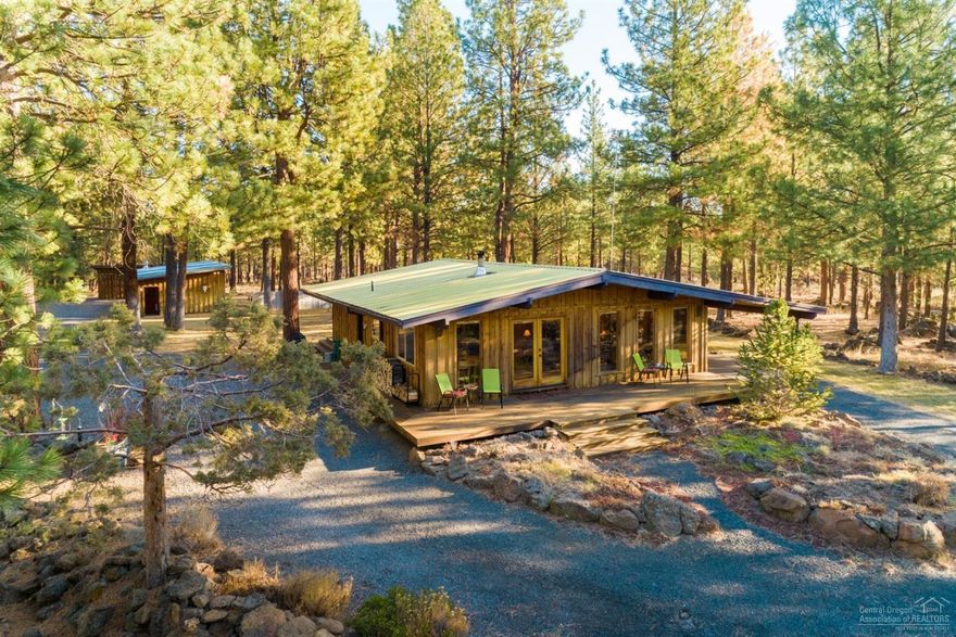 Meditate, write, paint, raise chickens, grow a garden, or simply relax among your own private 60-acre-getaway a mere mile from the western town of Sisters, Oregon. View the North, Middle & South Sisters in the Cascade Mountain Range and striking sunsets from the welcoming front deck surrounded by lush landscaping and volcanic rock outcroppings. Bordering National Forest Land and the Peterson Ridge Trail System, ride your horses for miles and miles from your property. Grow your own hay with 5.6 acres of irrigation rights and irrigation equipment. Corral your horses and provide shelter with the historic Edgington Ranch Log Pole Barn and included fencing panels. Multiple buildings accommodate your every need with the main house, studio space, garage/shop, storage building and historic pole barn. Work from home with two office spaces attached to the shop. Neighboring properties approved for Conditional Use Permits include a dude ranch, artists workshop & specialty import automotive shop.