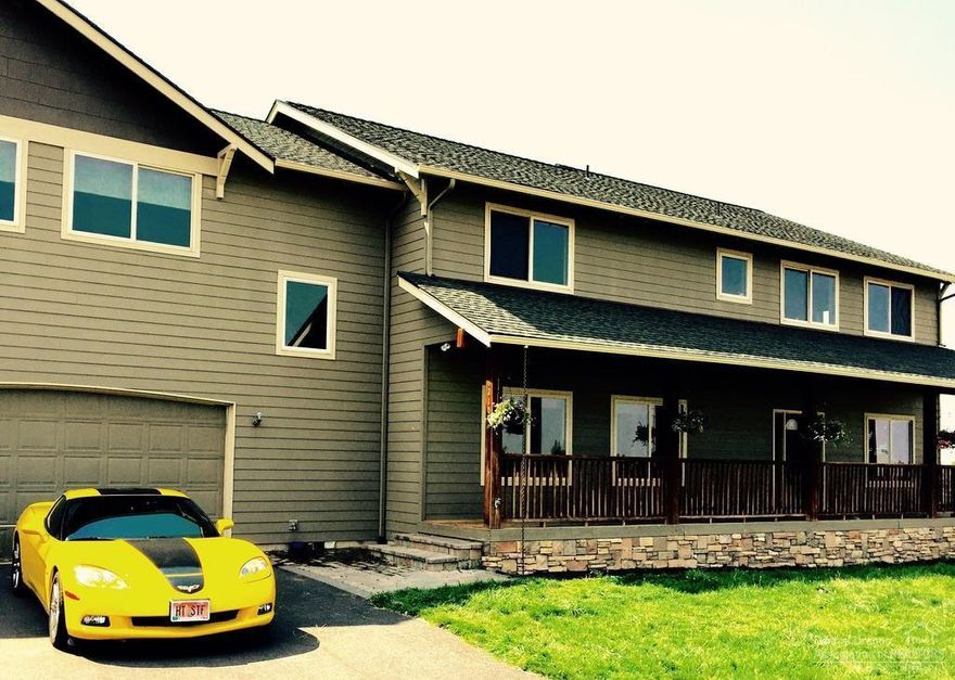 4535 SF custom home w/mtn views. Close to Bend, yet with a country feel. Huge water feature, heated paver patio w/fireplace, automated buried irrigation system, bass stocked pond, heated shop w/3-12ft doors. Sun room w/radiant heated floor & party kitchen, family kitchen/dining area w/hickory floors & large walk-in pantry, media room w/projection screen, living room w/propane fireplace & 6 floor to ceiling windows, office w/built-in desks & family room. Master bedroom w/bath & heated floors & tiled shower.