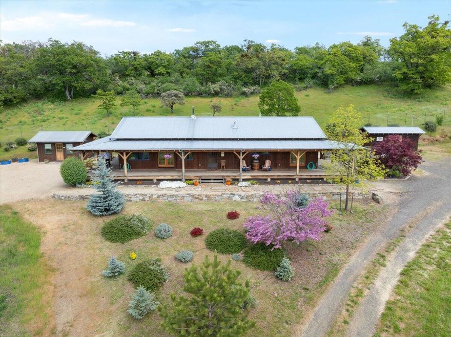 Nestled in the hills above Agate Lake outside Eagle Point, Oregon, you'll find peace and tranquility on this delightful 8 acre mini-estate and organic vineyard. 1680 sq ft custom home built in 2007, with 9' ceilings, Oregon Chinkapin hardwood, porcelain tile floors, interior timber beams and column, and abundant natural light from the Andersen casement windows. Relax and enjoy the setting sun from the 940 sq ft wraparound timber frame porch with views of the valley below, or entertain a dinner party in the garden pavilion built with traditional methods of Japanese joinery. 200 sqft detached guest studio and full bath adds versatile bonus living space. Numerous outbuildings: tool shed, greenhouse, and winery. This property has been lovingly maintained with pride of ownership demonstrated in every detail. Simply too much to list so call today for more information on this unique, private paradise.