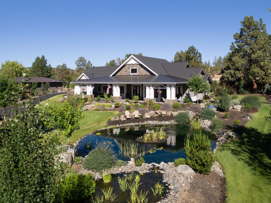 Premier home in Tumalo. Featuring 5 acres  along the Deschutes River w/ 300ft+ frontage. Fish from your river bank or take a great float. 3.07 acres of Swalley water rights. Professionally landscaped w/creek & pond w/waterfall. Fenced in veg/fruit gardens-1 w/raised beds. Large barn including  greenhouse, RV storage, loft & shop garage w/ 1/2 bath Welcoming covered front porch as you enter to your home. Vaulted ceilings in the living room. Dream kitchen with commercial 48'' Blue Star gas stove, Subzero, island, granite counters throughout the kitchen and  custom leaded glass cabinets. Primary master suite offers french doors to the patio, double vanity, heated tile floors, double headed shower, soaking tub, & walk in closet w/ plenty of room. 3 more bds plus office, work space and large laundry/craft room. Dining room w/boxed ceilings.  No detail overlooked. Oversized 3 car garage w/walk in shower, incredible storage. Paver patios for ease of care. An entertainers delight!