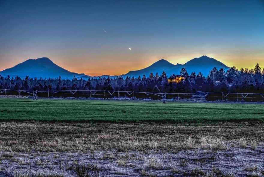 Expansive & Private! A gated property, 96+ acres w/55 acres, 3 Creeks irrigation water rights w pivot line X2, near forest service land (USFS), w/3 Sisters Wilderness. HUGE unobstructed Cascade Mountain, massive forest & grassland views. Three ponds, waterfall feature, wrap around deck, vaulted ceilings, large windows, hay barn, loafing shed, fenced horse pasture, paved driveway, room to build your dream shop/studio & CUP approval to build in the future (via administrative determination tbd w/county). Located between Tumalo & Sisters, and just 25 minutes from beautiful Bend, Oregon.