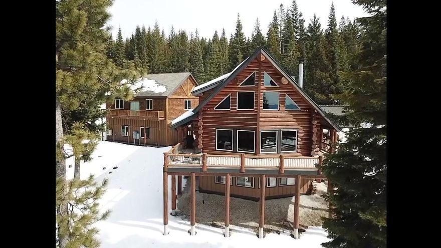 This majestic 3 bdrm 2 1/2 bath mountain home is constructed of fully hand scribed 12-15 inch Douglas fir logs with chinking.  Douglas fir log purlins support the roof and prow window wall.  Fantastic sweeping views of Crescent lake & Cascade mountain range. Rustic.quality ''heavy sawn'' wood trim & Ponderosa pine log w/burls & knots thorough out. Four panel stained hardwood doors with oil bronze hardware.  Fireplace faced with heavy rustic Montana mossy rock. Master bath w/dual sinks, oversized shower w/ smooth pebble stone floor & dual shower heads.  This 3 story fully furnished home has large floor to ceiling prow windows, hardwood floors, slate entry, stone counters, propane starter for wood burning fireplace, forced air with heat pump, trex wrap around deck, w/log accent rails.   Plumbed for entire house backup generator & hot tub, buried propane tank. Wet bar & game room in daylight basement.  Oversized detached heated garage with an additional 1200 sq. ft. living unit above.