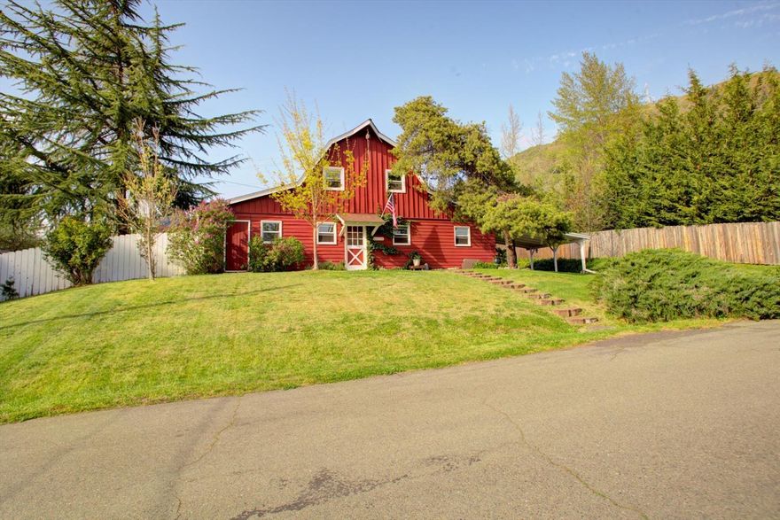 TWO homes for the price of one! Very unique home with LOTS of character. Live in the city with a country feel. The house is situated on a 0.25 acre lot with Grants Pass Irrigation. The main house is 1580 sq ft with 3 bedrooms and 2 baths, nice laundry room, great country kitchen, wood floors, and the main living space has an open feel. The guest house is 441 sq ft with 1 bedroom and bath. The property also has a 13X15 shed/workshop with electricity that has many possibilities. Lots of room for gardening. Peaceful with the most amazing view of valley and mountains. Has city services and near shopping. Comes with 1 year home warranty.