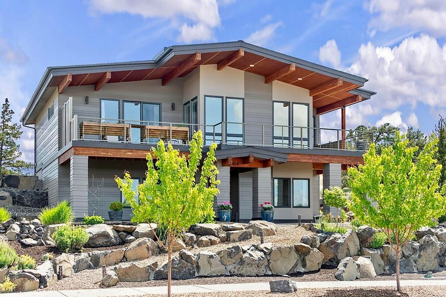 Experience luxury living with unobstructed, amazing, Cascade Mountain views in this custom architect-designed home in Madras' prestigious Yarrow subdivision. Thoughtfully crafted with custom, one-of-a-kind finishes, this open-concept home features a chef's kitchen with stainless steel appliances, hardwood floors, heated tile floors in the primary bathroom, walk-in closets and a heated garage. The spacious primary suite includes a sauna, dual vanities, porcelain walk-in shower, and access to a large, weather-resistant aluminum deck with exposed beams—perfect for year-round enjoyment. The lower level offers potential for separate living quarters. Outside, enjoy a private courtyard, hot tub, xeriscaped landscaping, and RV/boat parking. Close to the Madras Aquatic Center and outdoor recreation.