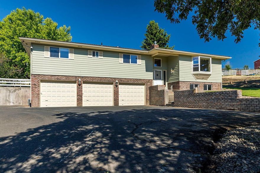 Beautiful well built home close to town, yet in the country! Featuring 2,700 sq.ft. +/- living space, 3 bedrooms, 3 baths, plus a big rec room and a den/ office downstairs. All with gas heat & A/C. Country kitchen with garden window, eating bar, tiled counters, & bay window with seat, in dining room and the living room to enjoy the gorgeous mountain views and cozy gas fireplace. All on 2.93 fenced acres with an incredible 48x41 HEATED SHOP with 12' door . Also has 110 & 220v power, bath, plus RV bay with full hook ups, and a barn for animals. 3 car garage and tons of storage. Upgrades include vinyl windows, composition roof only 2 years old, new exterior paint of home and shop. Lovely covered patio and nice mature landscaping and raised bed gardens.