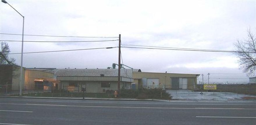 Building amenities include: fully insulated, 26 ft ceiling height, 8 in concrete floor, open clear span, 4 roll up doors main 18x18, pre-plumbed for air. HUGE power 1200 amps 3 Phase, 408 3 Phase, 208 3 phase and 120 Single Phase. Recent complete retro fit energy efficient lighting with auto on/off. Keypad automatic gate entry. Fully fenced. Paved enclosed on 3 sides with 20 foot tall ceilings for a total of approx. 15,564 sqft. Out space available paved & gravel logistic area. Adjacent to railroads Spur. Truck bed-eight loading dock.