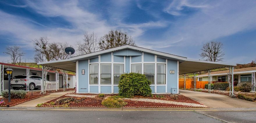 Affordable home in Mountain View Estates, a 55+ park in Talent. New laminate wood floors just installed in most of home. This 2 bedroom, 2 bath home has an enclosed patio/sunroom which offers additional living space. The primary bedroom has a walk-in closet. The primary bathroom offers double vanities, skylight and tiled floor. The second bedroom is nice guest space or an office. There is a formal living room with dining area and a family room/den off the kitchen.  According to the seller, the roof is about 5 years old, dishwasher is 3 years, water heater is 4 years. Washer & Dryer included in the large utility room. The heat pump has heat strips for emergency heat on cold nights. The shed at the end of the carport has a workbench. New fence in 2020. There is a ramp at the front door for easy access. The seller is providing buyer with 1 year home warranty with First American Home Warranty, Value Plan for $440.