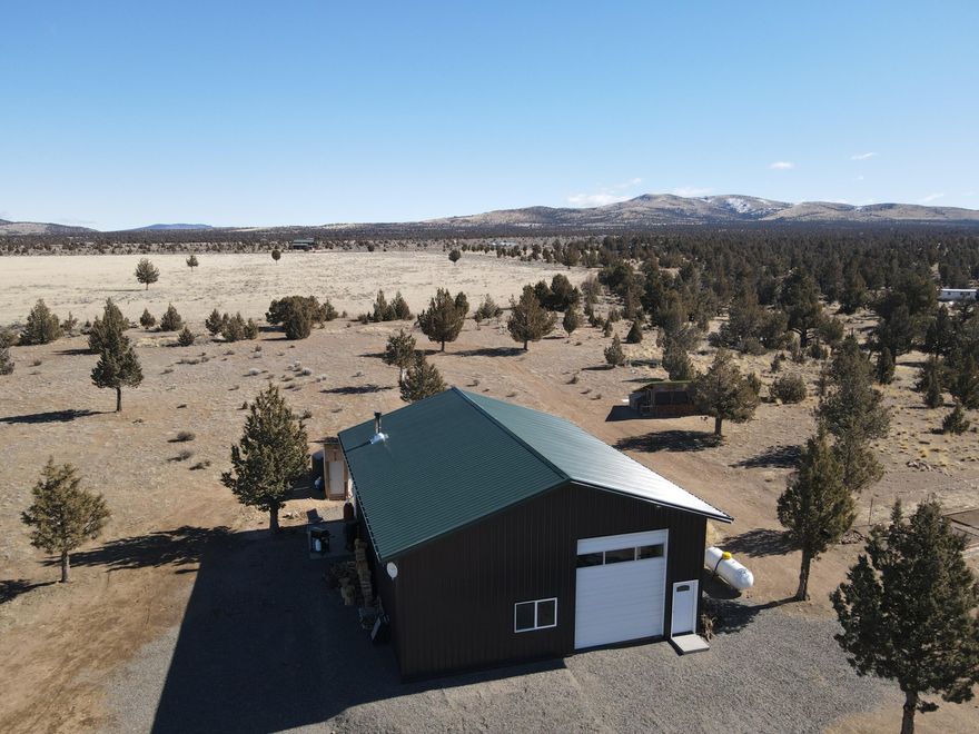 Beautiful, buildable, fenced 10 ac off-grid stargazer's paradise w building site plan approved. Thousands already invested in infrastructure - build your year around or
dream vacation home easier and more affordably. Or simply hook up your RV(s) - there are a total of 5 RV sites - to the existing power, water, and septic systems - all installed since 2018! Tremendous Cascade Mtn views from south of Mt Bachelor and the 3 Sisters to Mt Jefferson. Newer 36x48 - 1728sf - insulated pole barn w/ large RV door, 2 man doors, shop lights, lots of windows, cell phone signal booster & full RV hookups offers plenty of options. Solar power system w 1600W solar array, Outback Solar Charge Controller, new hi-efficiency, low maintenance Lithium Iron Phosphate batteries projected for 20 yrs of service w/ 10 yr warranty, AIMS Inverter/Charger, &  connection to charge batteries from propane-compatible generator. Septic system installed & approved for 2500sf, 5 bdrm home. 3000gal cistern and so much more