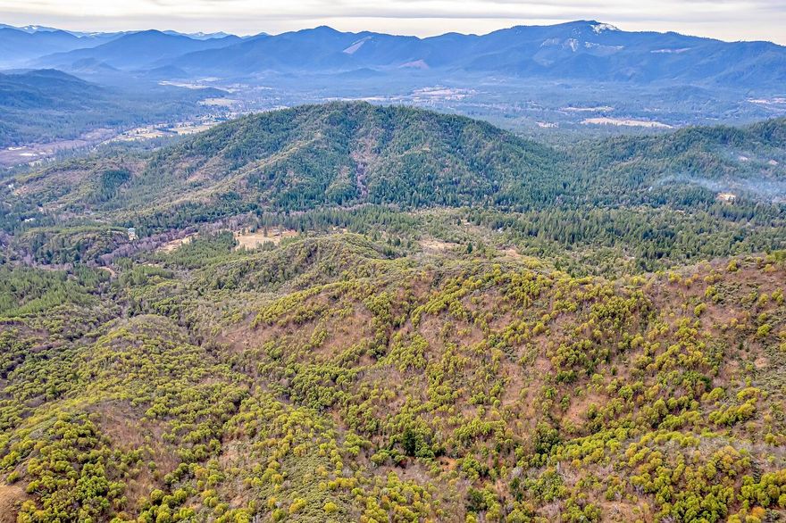 Rare opportunity to own a full section (±640 acres) of Southern Oregon land just 12 miles north of I-5 and the city of Rogue River. Privately situated off Sykes Creek Road, this expansive property offers both seclusion and convenience. Easement roads lead to the gently sloped western portion, offering potential for a homesite, while a network of trails provides access to the more rugged terrain. The land is ideal for recreation—hunting, hiking, camping, and more. Wildlife is abundant, including deer, bear, turkey, and cougar, and the property lies within a known deer and elk winter range. Whether you're looking to build a private retreat, enjoy the outdoors, or invest in a rare large-acreage tract close to town, this property presents endless possibilities in a beautiful and unspoiled setting. Buyers to perform all due diligence with Jackson County with regard to development potential.