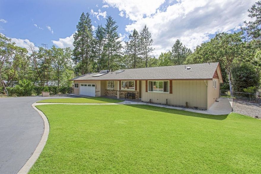 Colonial Valley! Peaceful and beautiful setting in the Woodland estates. 3 bedrooms, 2 baths and 1517 SF on 1.22 acres. Since 2006, owner has put in over $120,000 in upgrades to the property. Kitchen has skylight, granite counters w/ tile backsplash and counter seating. Living room features wood burning fireplace, laminate wood floors, built-ins, skylight, ceiling fan and sliders to the backyard. The backyard is a park-like setting with mature landscaping and privacy. Large covered patio provides a great entertaining space and indoor/outdoor living. Sprinkler system throughout, water feature, seasonal creek and grapevines. Water softener and 6 GPM well. 26x32 shop, garden shed and dog kennel. 2 car attached garage, RV parking and circular driveway. Public utility power plus $23k grid tie solar electric. New 30 year roof in 2006.