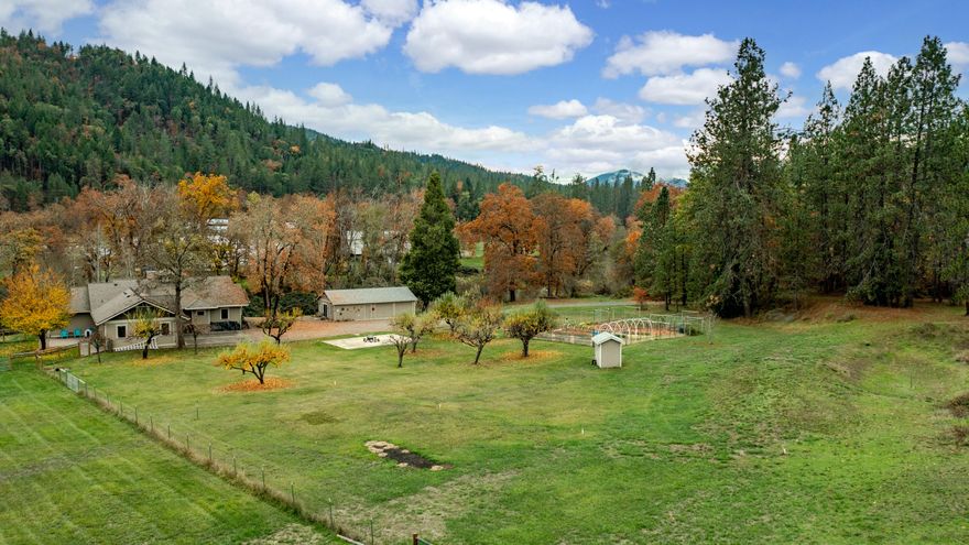 Stunning 8.68 acre setting on Evans Creek. Top quality, open concept custom built Earth Advantage home. Travertine entry and hardwood throughout living area. Vaulted great room features a high efficiency fireplace, rock surround, raised hearth & carved mantle.  Kitchen boasts Granite counters & backsplash, eating bar, Knotty Alder cabinets, convection oven, microwave + warming drawer. Dining & living area features picture windows overlooking the Creek. Vaulted master suite offers double walk-in closets & deck access. Attached master bath includes double vanities, granite counters, heated flooring & oversized slate shower. Indoor laundry room w/ built-in desk, sink and extra storage cabinets. Wrap around deck provides great outdoor entertaining space. Detached 800 SF workshop w/ guest quarters. Fruit trees, expansive garden, fenced 2.5 acre pasture w/ granted 1896 irrigation rights, an enclosed paver patio area conveniently located behind the attached two car garage including sauna.