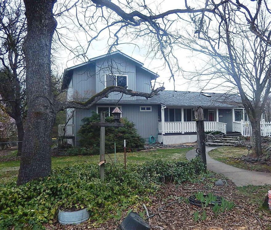 This place offers the ultimate in country living only minutes from downtown & shopping conveniences. Nestled back off the road, enjoy the quiet in your own private oasis. Large custom home has been designed for multi-family living. 5 Bedrooms and 4 full baths - essentially three Master Suites. Big beautiful kitchen provides a multitude of solid wood cabinetry, gas range, lots of counter space & big skylites providing a bright & cheery atmosphere. There are two Laundry rooms & two water heaters to provide fast hot water to both ends of this amazing home. Spacious covered back deck provides gas hook-up for Bar-b-que & looks out to the beautiful yard with TID irrigation. Giant Garage/Shop totals over 1,400 sq ft & includes another full bathroom. Second Shop is approx. 700 sq ft. Both provide 220 power. Home has a brand new roof with transferable warranty. Also freshly-painted exterior. The amazing Well shows 45+ gpm when drilled. RVSS provides an efficient Septic Tank Effluent System.