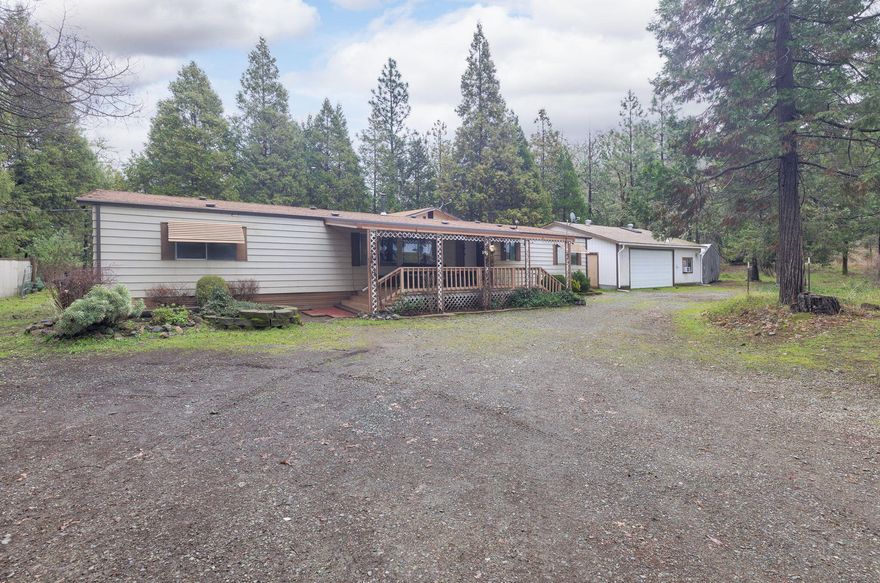 This is what you are looking for! Four-bedroom, three-full-bath manufactured home, two full, split primary bedrooms and two full primary bathrooms on each side of the home. Nestled on a sprawling 6.14-acre property. This spacious residence spans over 2,520 SqFt, offering ample space for comfortable living. One of the standout features is the picturesque Madronna Creek that gracefully flows through the property, creating a serene and tranquil atmosphere. The property boasts a level landscape, perfect for outdoor activities, and is fully fenced for added privacy and security.  For those with a passion for tinkering or needing extra space, a spacious 30 x 40 garage shop awaits, complete with a 220 amp setup. Discover the perfect blend of natural beauty, functionality, lots of extra space and conveniently close to town.