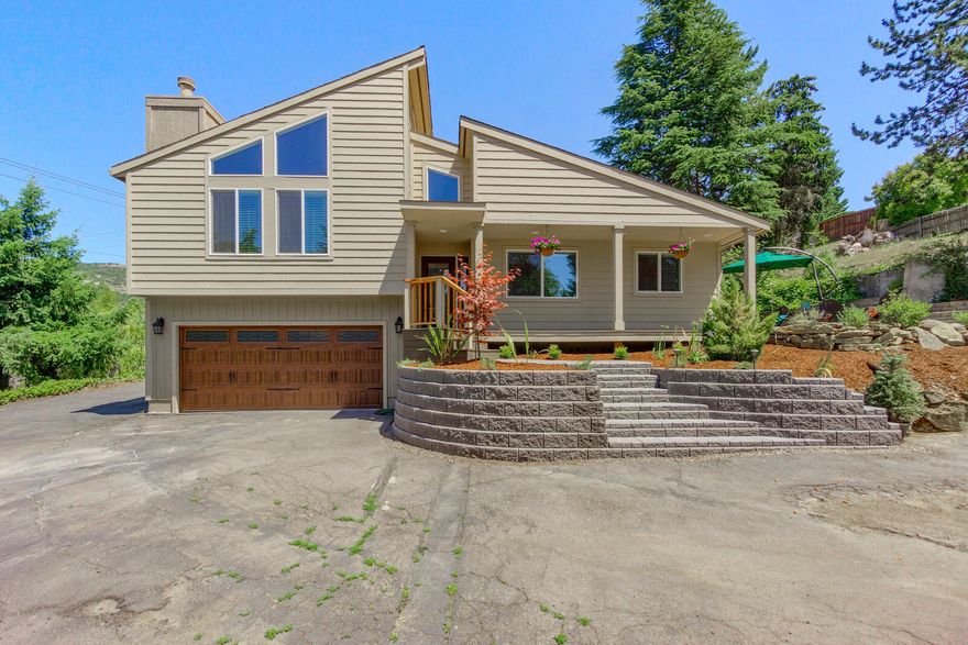 Beautiful updated contemporary home in East Medford. This split level home has the kitchen, dining, bathroom, laundry and 1 bedroom on the main floor, with only a few steps to your second lvl, which features the living room and master suite. The living rm has large, brand new windows that offer sunlight and tall ceilings. The master bedroom has a walk in closet, step in shower and deck. A few steps up to the ''third'' floor and you have your third bedroom with a spacious loft that adds size to the room by offering a nursery, office, music or play area. This room also has a sliding door to a deck. Multiple decks, one of which is a brand new Trex deck, the side yard is a great flat entertaining space with tiered retaining walls and landscaping that offers beauty and low maintenance. Lots of lovely NEW upgrades-- the West and South walls have all new exterior siding, the front entry, garage door, some fixtures, some electrical and plumbing, landscaping and laminate flooring. A must see!