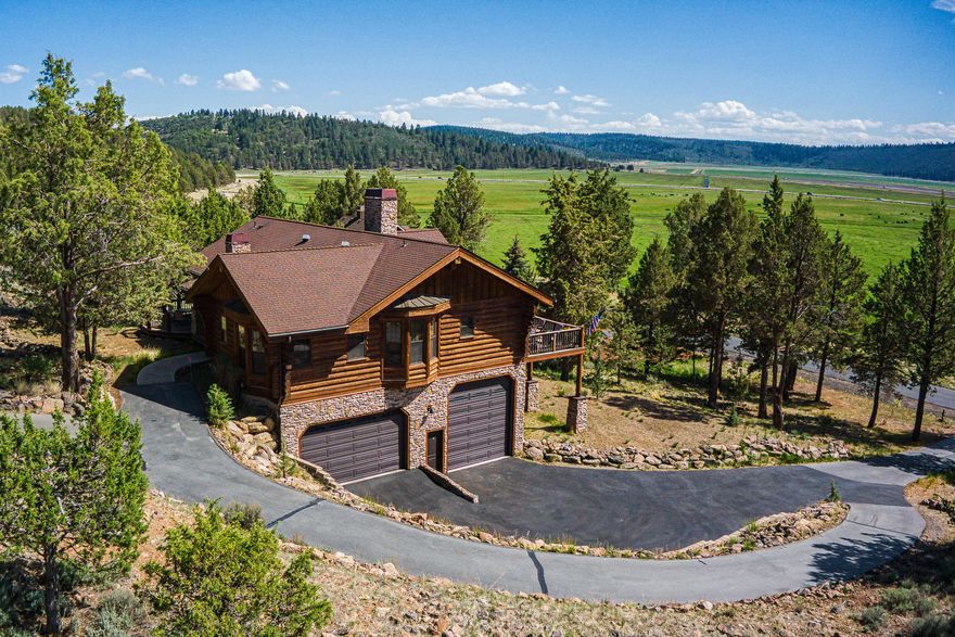 Bask in the beauty of Central Oregon surrounded by protected land in the upscale Running Y Resort! This 4 bedroom, 3 bath SFR embodies the charm of a log cabin yet features the details of a custom-built home. The main floor entrance opens to vaulted ceilings, a cozy living room with a dual-sided gas fireplace that connects to the gorgeous sunroom, perfect for watching the sunset. This home features a custom-built kitchen and dining area with expertly crafted cabinetry. The main floor master bedroom boasts French doors that open to a private porch as well as an attached master bath with jacuzzi tub and heated flooring. The lower level features 2 additional bedrooms with a third full bath. The spacious laundry room leads to the two car garage with additional parking for a 32 foot RV. You will also have access to the amenities of the Resort, including the Arnold Palmer Signature golf course, fitness center, pool, trout lake,  restaurants, etc. all on property!