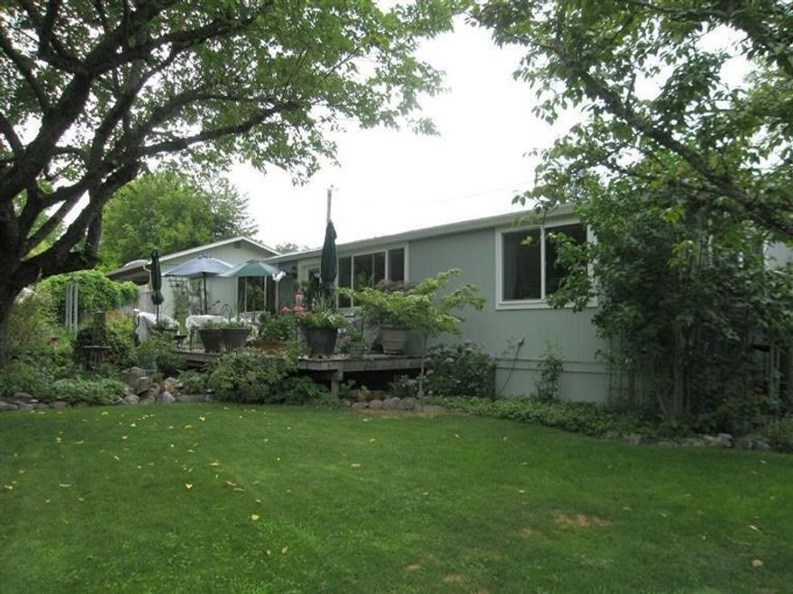 Enchanted and Peaceful are the feelings you get when you walk onto this wonderfully loved and cared for property. This 1978 manufactured 3BR/2BA, 1,344 sqft home is light bright and warmly welcoming with a pellet stove. This home has been completely up graded including wood siding and a lovely deck to enjoy the gardens. Second 792 sqft detached studio was built in 1999, can be used as a guest space, artist studio, rental or shop. Has a finished single car garage. 0.63 acre and filled with nature's lush beauty, lots of hummingbirds, blue birds and a beautiful fish pond.