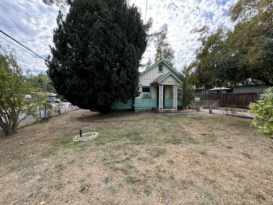 Come put your touch on this diamond in the rough in SE Grants Pass.  With great proximity to Riverside Park, to Baker boat ramp, and access to all your shopping, banking, and daily societal needs along the parkway, 523 SE Riverside provides a convenient location and a corner lot with loads of potential! The modest cottage measures just over 600 square feet and offers a fenced property with a detached workshop and also alley access onto the property.  Ideal for a remodel or even to be redeveloped, this zoning would allow for the construction of multi-family units or the construction of an ADU for multi-family or multi-generational living.