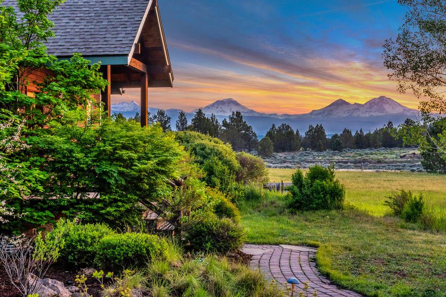 Indulge in this exceptional property, where expansive Cascade Mountain views leave you in awe. Nestled in scenic Tumalo, this expansive 9.7-acre parcel, with 6.1 acres of lush irrigated land, is a true oasis. The charming 1,877 sq ft home, with 3 bedrooms and 2 baths, captures the serene beauty of the mountains from sunrise to sunset. The sprawling flower garden with covered gathering area beckons outdoor dinners with friends and family. Additionally, two bright barn/studios await, bathed in natural light and boasting vaulted ceilings, glass roll-up doors and captivating vistas. The possibilities are endless. After a one-in-a-million sunset, frogs and owls begin their serenade as the night sky sparkles with unbelievable stargazing. It's hard to believe this is only 10 convenient miles to Bend's vibrant shopping, dining and entertainment scene. Direct access to thousands of acres of public lands. Upgrades valued over $100,000, including a new private well and perimeter fencing.