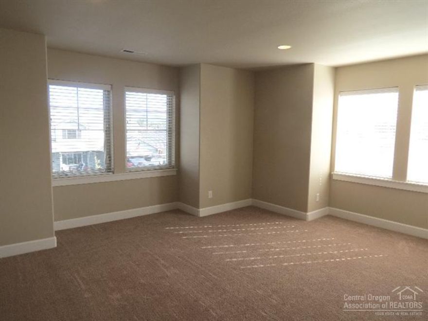 Large 2,127 SF home in SW Redmond. Easy access to Bend and all that Redmond has to offer. 3 bedrooms, 2.5 bathrooms with bonus room. Gas fireplace in the great room, open kitchen with stainless appliances and eating bar. Master bedroom features Cascade mountain view and walk-in closet, double sinks, tile counters and soaking tub. New carpet throughout and fresh exterior paint. Large yard with sprinklers. This home is vacant and ready to move in to.