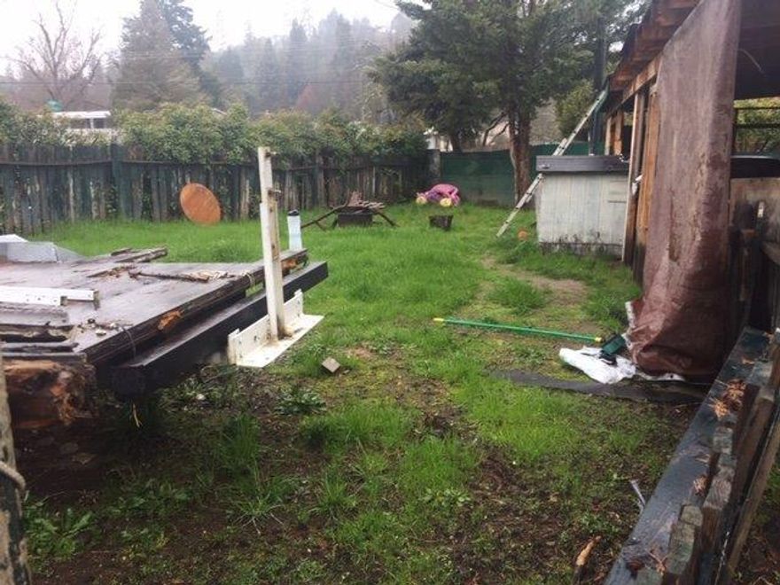 Great building location in an established neighborhood near the Rogue River Hwy commercial area. The property is fenced, on city sewer and has a well. The existing mobile home is rented, but the seller is not giving it any value. The value is in the land! Seller is motivated. Buyer to do their own due diligence regards all aspects of this property.