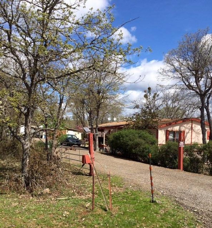 Beautiful Eagle Point acreage. This 3 bedroom, 2 bath 1344 square foot double wide manufactured home rests on 9.62 level acres. Built in 1991, it has a one car detached garage and is surrounded by mature oak trees.