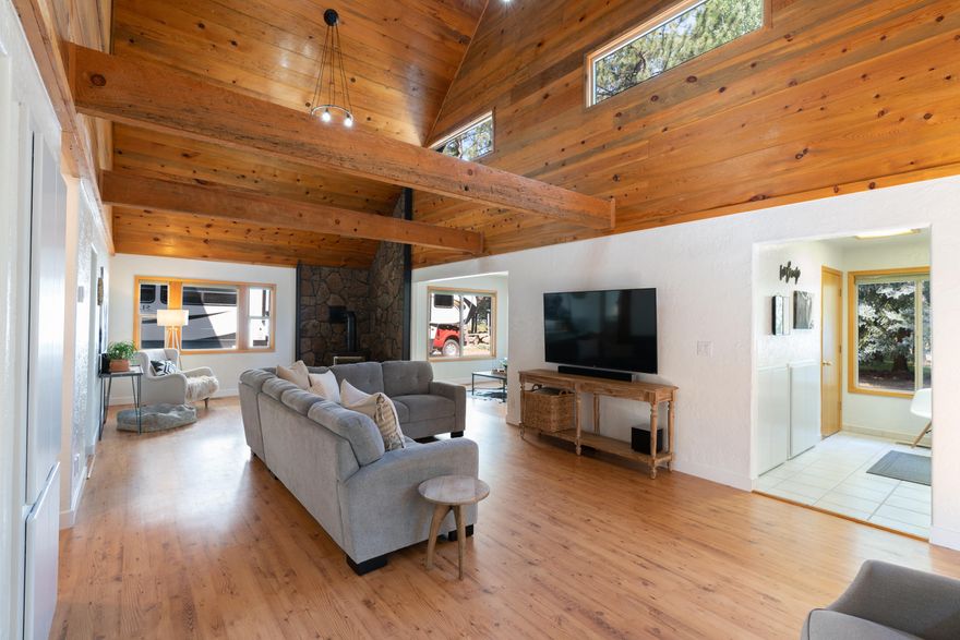 Located just minutes from Sunriver, this fully renovated 2 story on a half-acre lot will delight. Tasteful and abundant  renovations have been made through out. Grand vaulted living area with exposed beams and ''knotty pine'' ceiling. Separate sitting area w/dry bar. The chef will love the ''grand'' sized kitchen with solid surface counters, cabinets galore and new Kitchen Aid appliances. Adjacent dining room with room for the largest table. Convenient mud room/half-bath with entry, adjacent the kitchen. main floor bedroom w/adjacent full bath. Top floor master is quite large, includes 2 separate closets, Travertine tiled bath and sauna! Enjoy a short 20 minute drive up to Mount Bachelor or into Bend. Deschutes River access is just a few blocks away, and the ever popular Harper Bridge access is 2 min down the road.