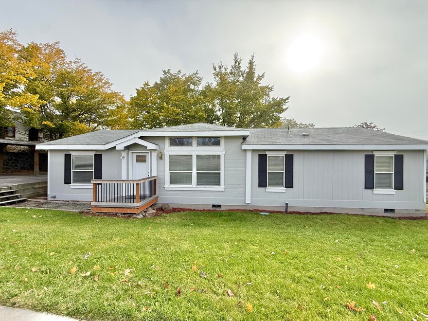 Immaculately cared for and truly turn-key, this beautiful home shines with newer flooring throughout and fresh paint. An abundance of windows fills every room with natural light, creating a warm and welcoming atmosphere. Featuring 3 bedrooms and 2 full baths, including a spacious primary suite with a walk-in closet, the thoughtful split floor plan offers privacy and functionality. Enjoy two generous living areas—perfect for entertaining or relaxing. This manufactured home sits on its own land with a permanent foundation and tie-down straps. Ample off-street parking includes a covered carport. Ideally located near downtown shopping, boutiques, restaurants, and just a short distance from the lake, Moore Park, OIT, and the medical complex. A perfect fit for downsizers, first-time buyers, investors, or anyone seeking a move-in-ready home with nothing left to do but unpack and enjoy!