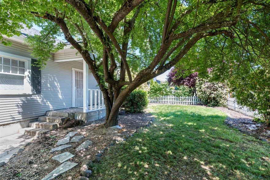 Fantastic First-Time Home Buyer or Investor Home Located in East Medford, Close to Schools, Shopping & Medical. Fantastic updates include new carpet, newer tall fencing in back yard for increased privacy & newer roof. White picket fence surrounds this adorable property which boasts an inside laundry room, bright & open kitchen including refrigerator with ice maker and garbage disposal, ceiling fans in dining and living room with a great brick fireplace to make the cold nights cozy. Big backyard with plenty of room for parking, including RV and additional storage behind the 2-car garage. Automatic sprinklers and gorgeous mature landscaping including a plum tree. Don't miss this great deal!